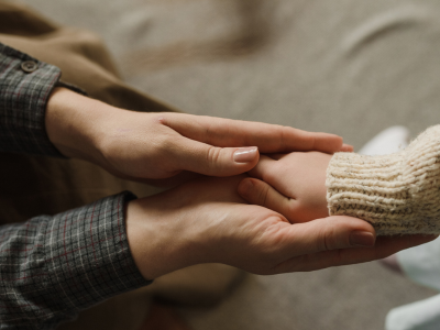 Parent and Child Holding Hands During a Custody Discussion.